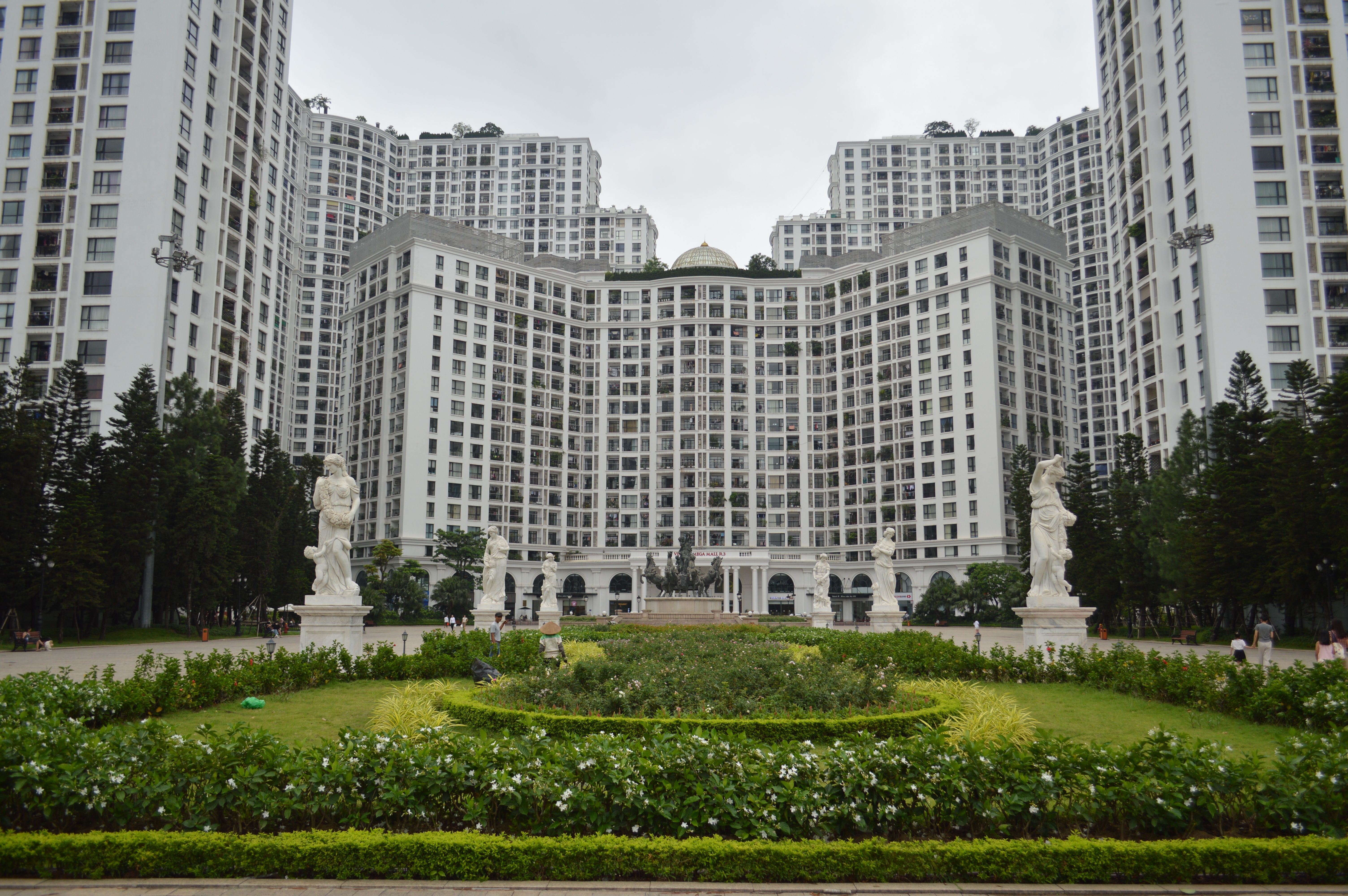High-rise residential buildings with statues and gardens creating a grand urban landscape.