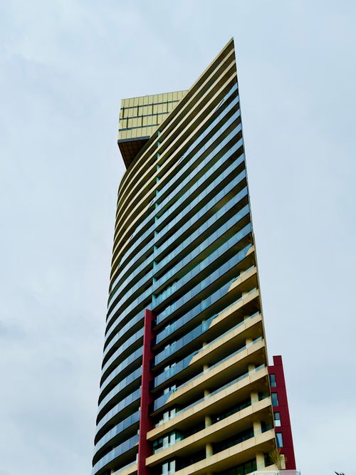Free High-angle view of modern skyscraper in Docklands, Melbourne, showcasing unique architectural design. Stock Photo