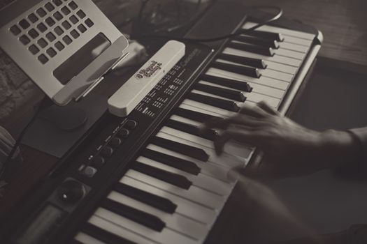 A vintage keyboard setup in a moody home studio, perfect for artistic music creation.