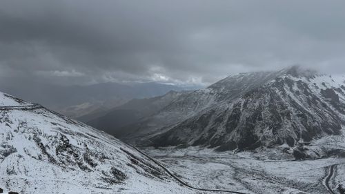 Free Breathtaking snow-capped mountain range in Leh under cloudy skies. Stock Photo