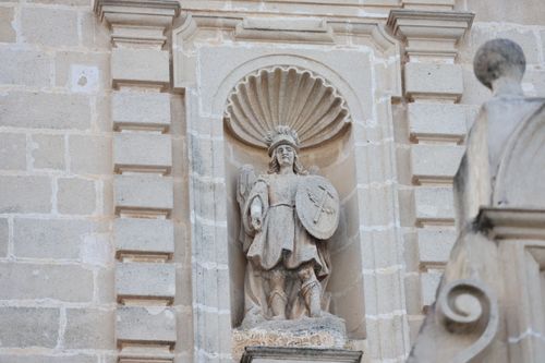 Free Detailed view of a historic stone sculpture on a building facade in El Puerto de Santa María, Spain. Stock Photo