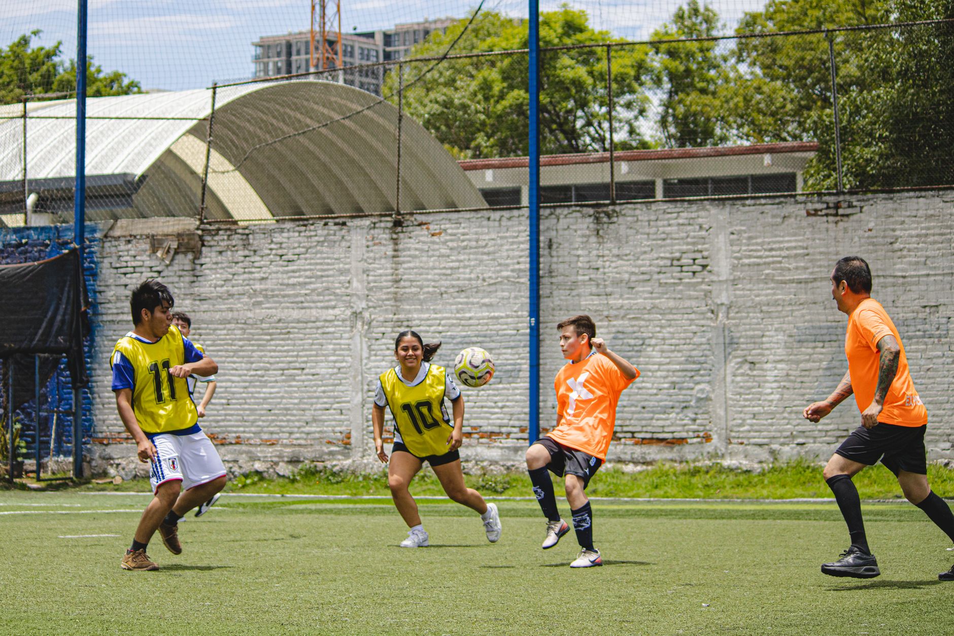 Vibrant youth soccer game in Mexico City focusing on teamwork and competition.