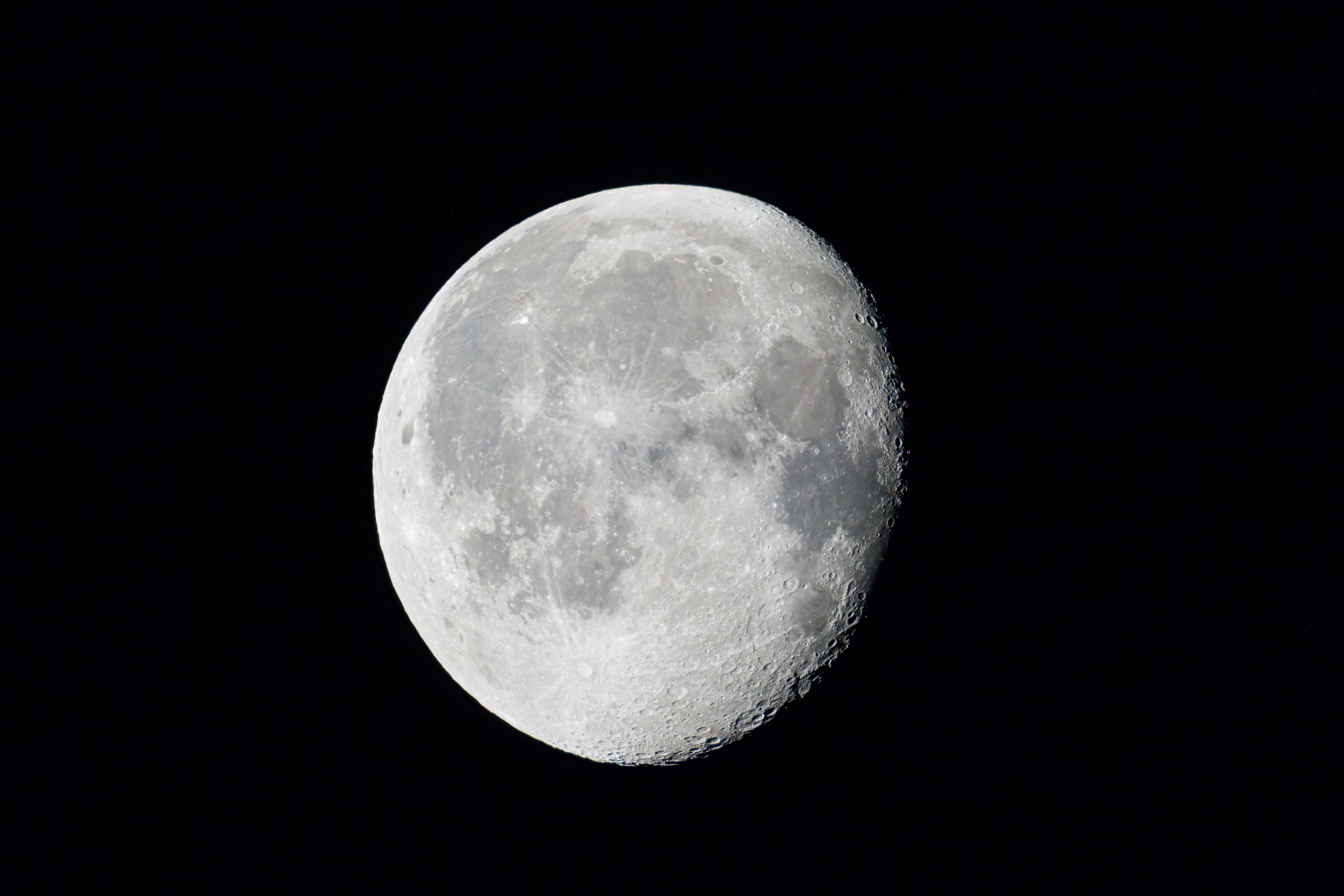 Crisp view of the waning gibbous moon captured over Darien at night.