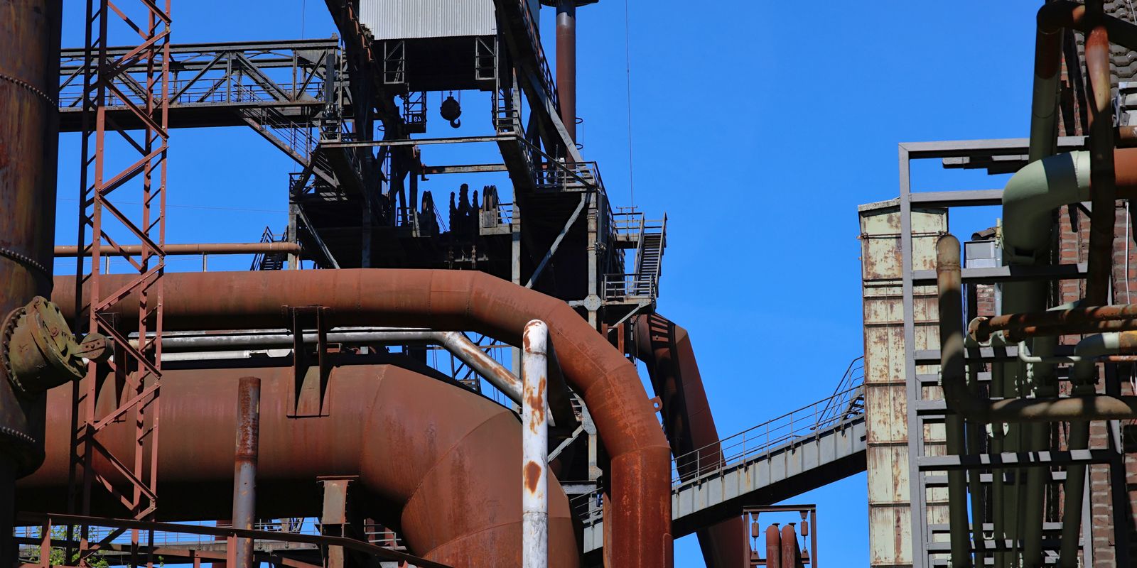 Rusted steel pipes and structures at an industrial complex