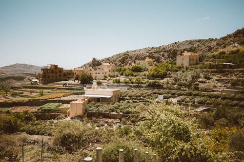Free Beautiful terraced farms at Jebel Akhdar in Oman showcasing rural architecture and lush greenery under a clear sky. Stock Photo