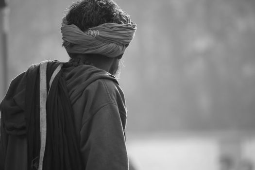 Black and white side profile of a man wearing a turban in Prayagraj, India.