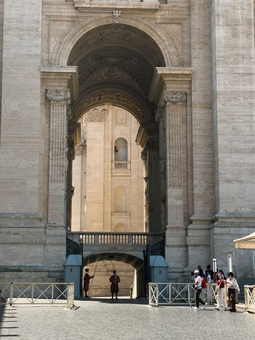 Free Explore the majestic grand archway entrance of Vatican City with guards at the gate. Stock Photo