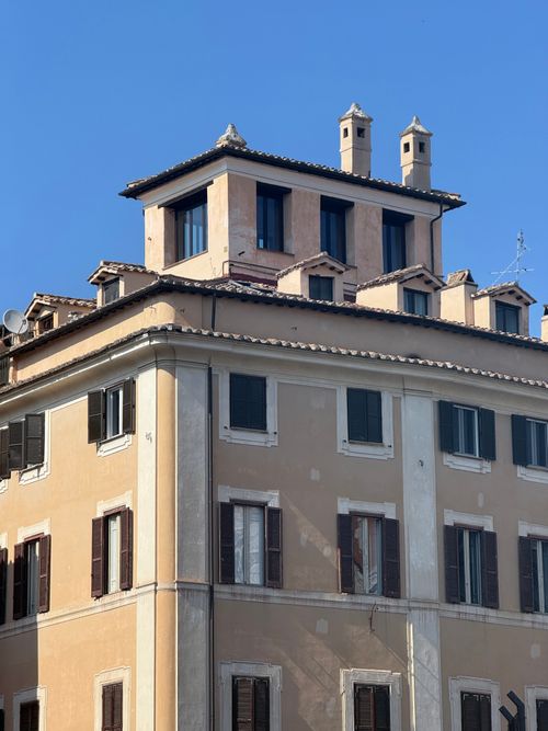 Free Elegant Roman building with classic design and clear blue sky background. Stock Photo