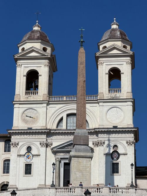 Free View of Trinità dei Monti church and obelisk under a clear blue sky in Rome, Italy. Stock Photo