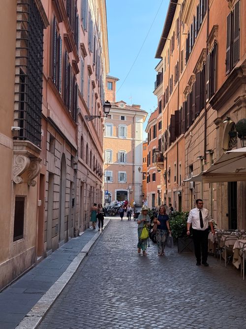 Free Cobblestone street in Rome showcasing Italian architecture and city life. Stock Photo