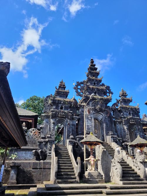 Free A stunning Balinese temple with intricate architecture against a bright blue sky in Bali, Indonesia. Stock Photo