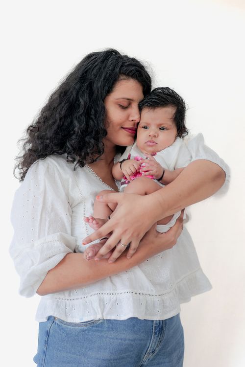 Free A loving mother cradles her baby, exemplifying tender motherhood and familial bonds. Stock Photo