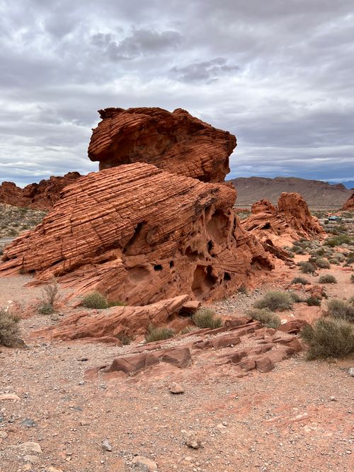 Free Explore stunning red rock formations under a cloudy sky in a desert landscape, displaying natural beauty. Stock Photo