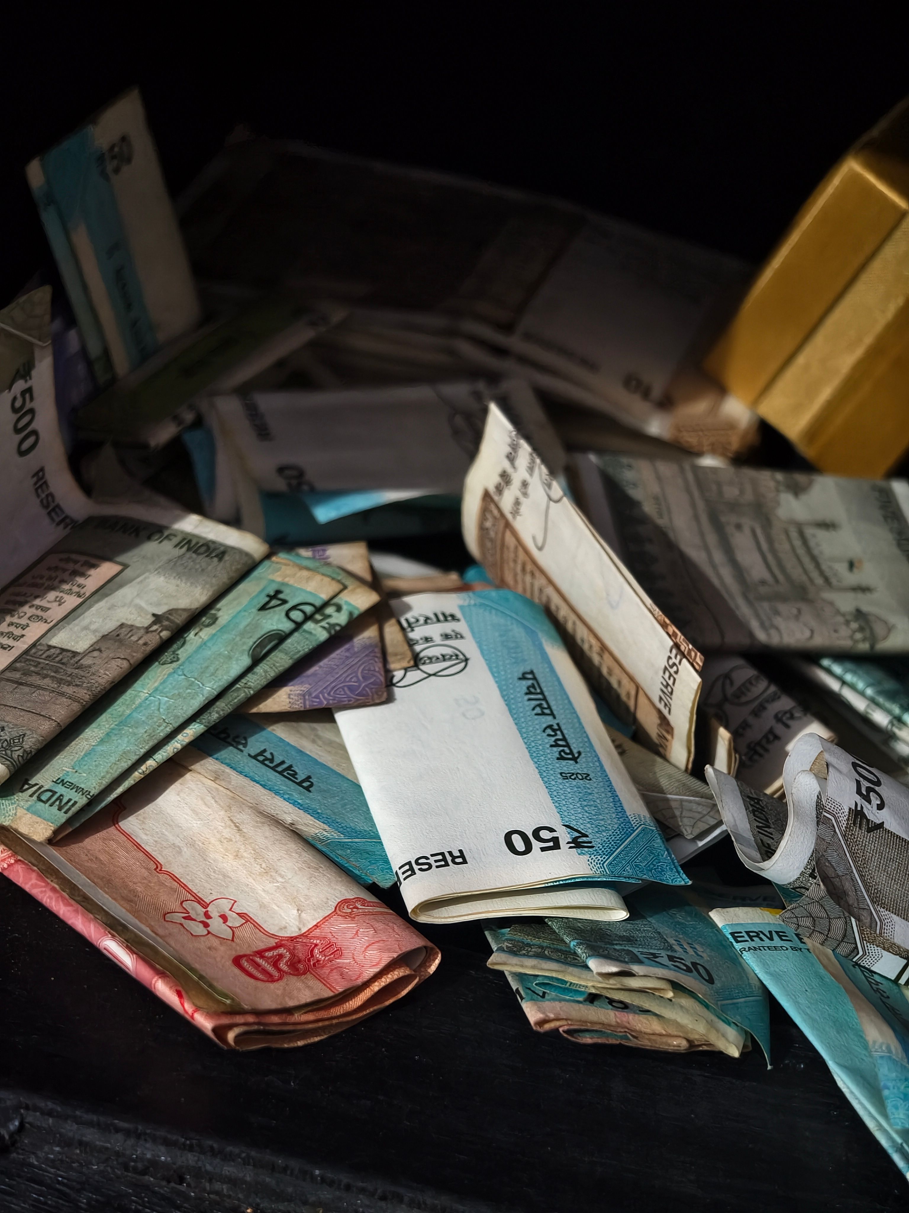 A variety of international banknotes scattered in a pile, highlighting global currency exchange.