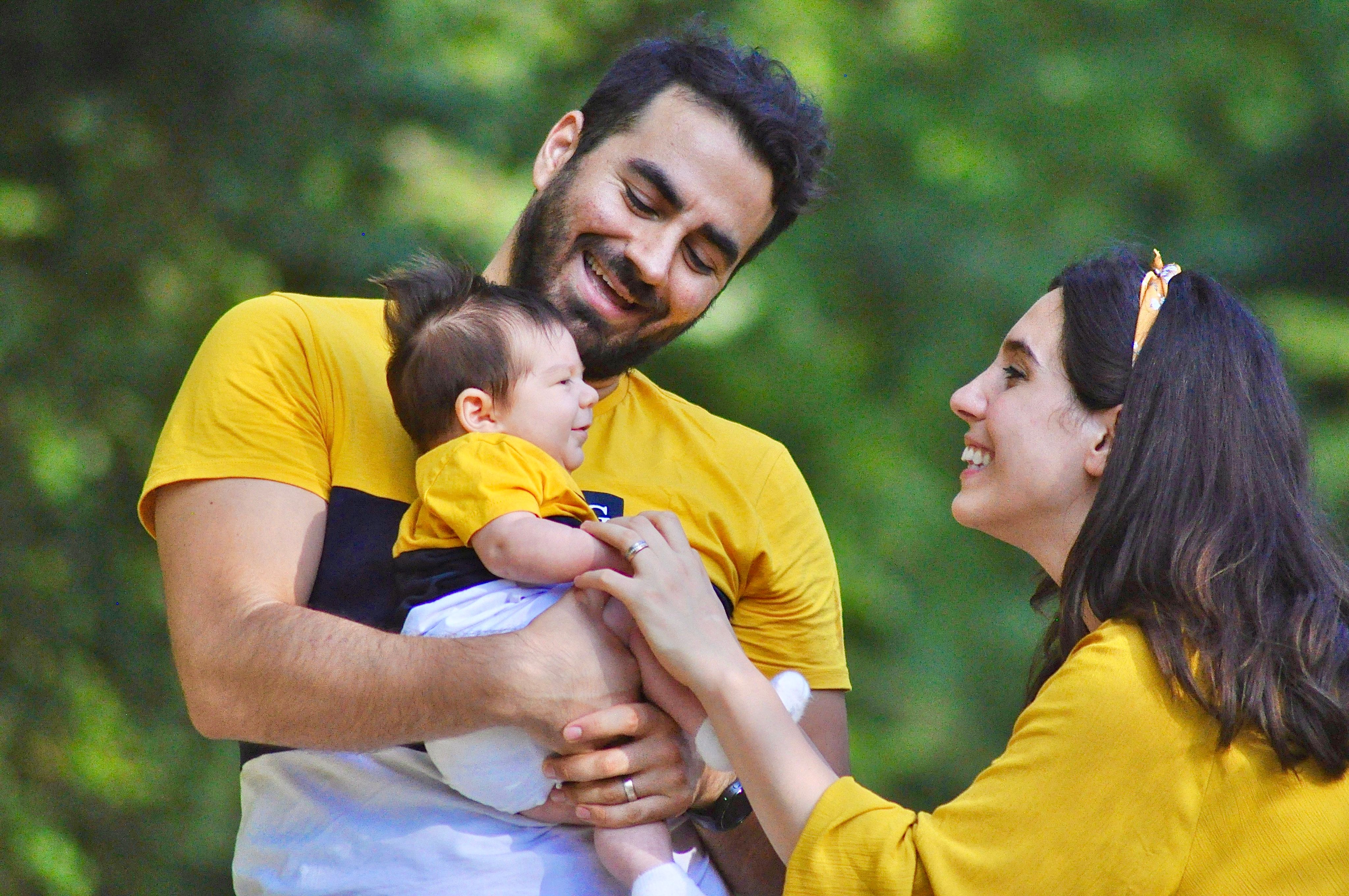 A happy family shares a joyful moment outdoors, depicting love and togetherness.
