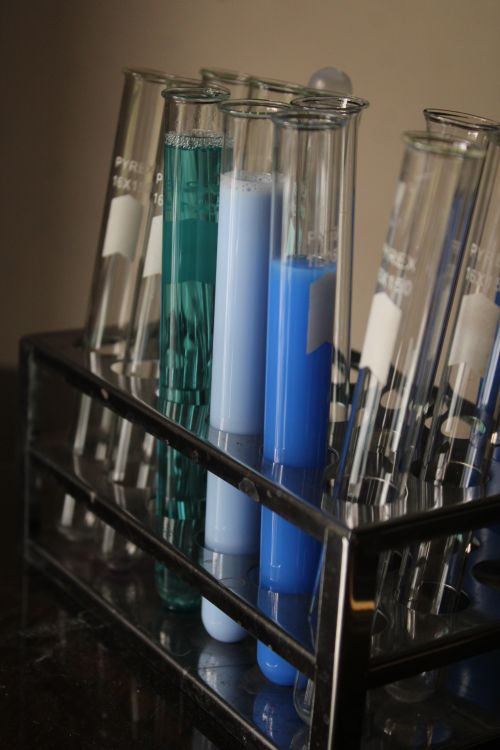 Free Close-up of test tubes with colorful liquids in a laboratory setting, ideal for science themes. Stock Photo