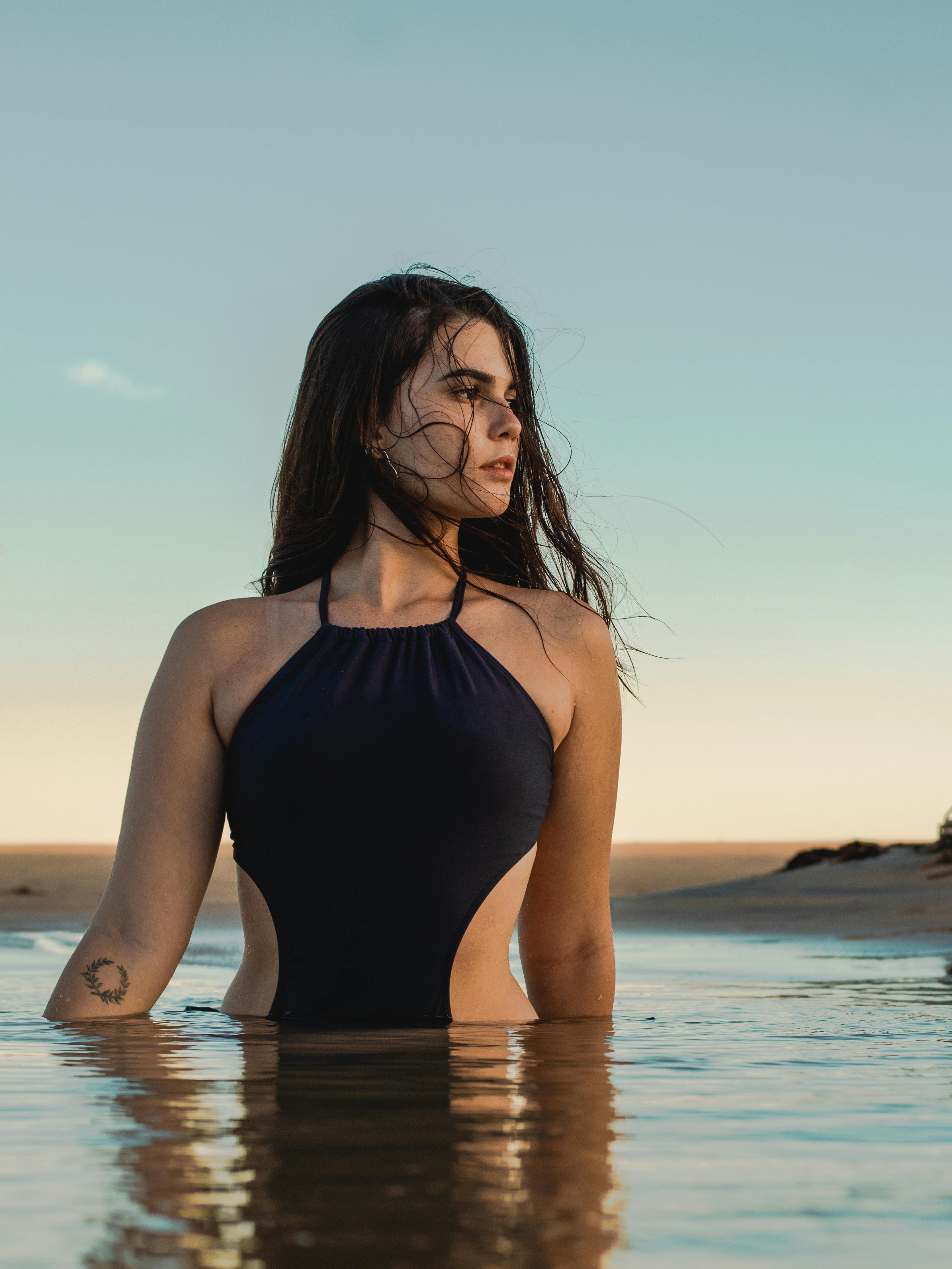 dreamy slim woman standing in water