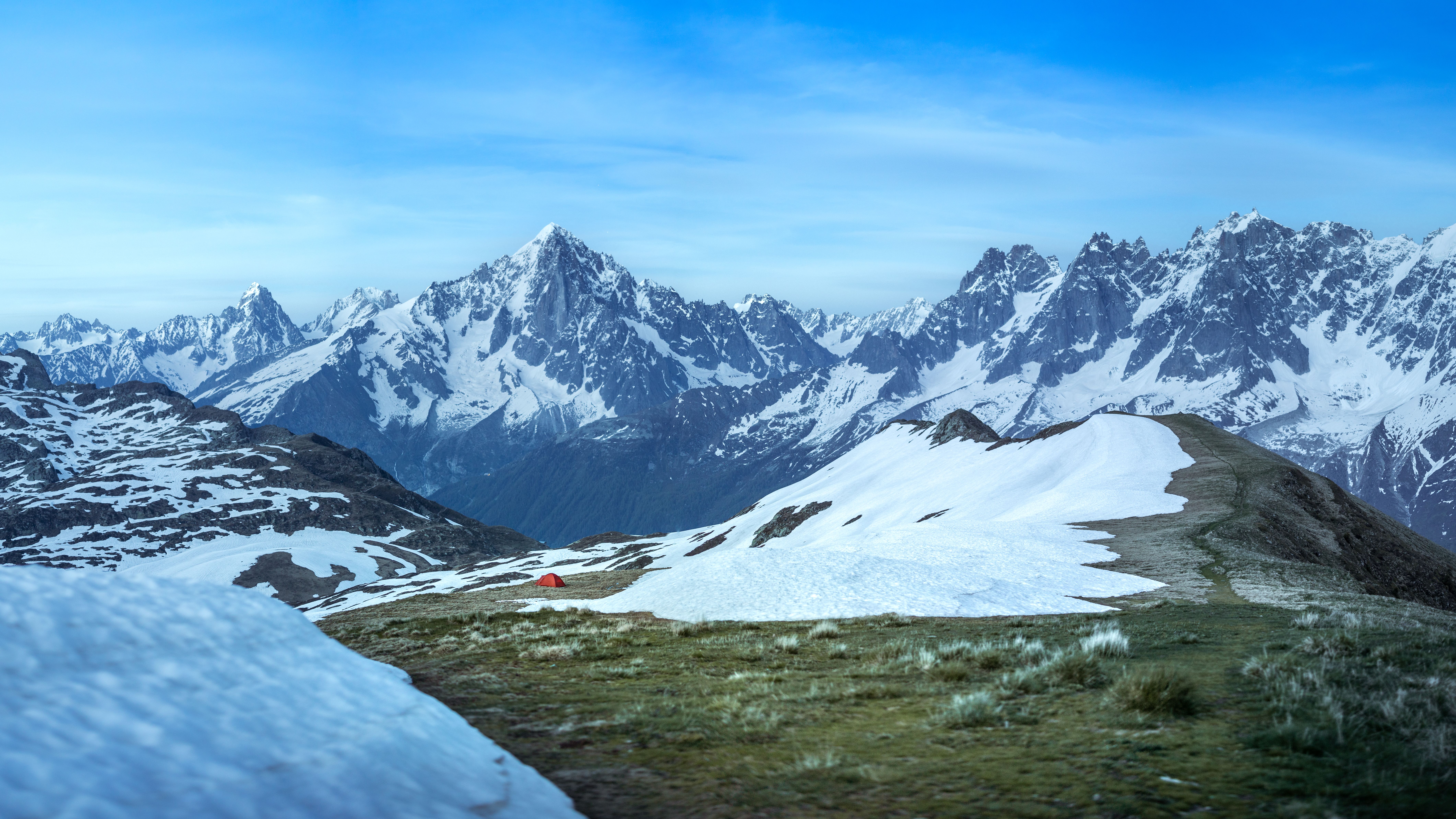 Explore the tranquil beauty of the French Alps with a lone tent amidst snow-capped peaks – best gear for pct