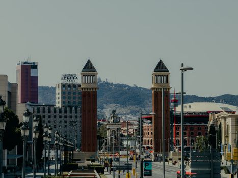 A daytime view of the iconic Venetian Towers and surrounding buildings in Barcelona.