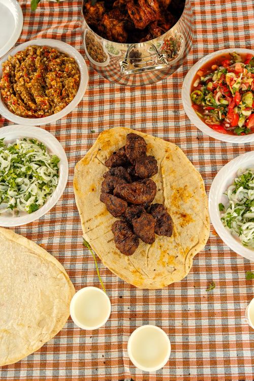 Free A vibrant arrangement of Middle Eastern dishes on a checkered tablecloth, showcasing a feast of flavors. Stock Photo
