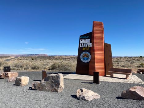 Grand Canyon West entrance sign with rocky desert landscape in Arizona, USA.