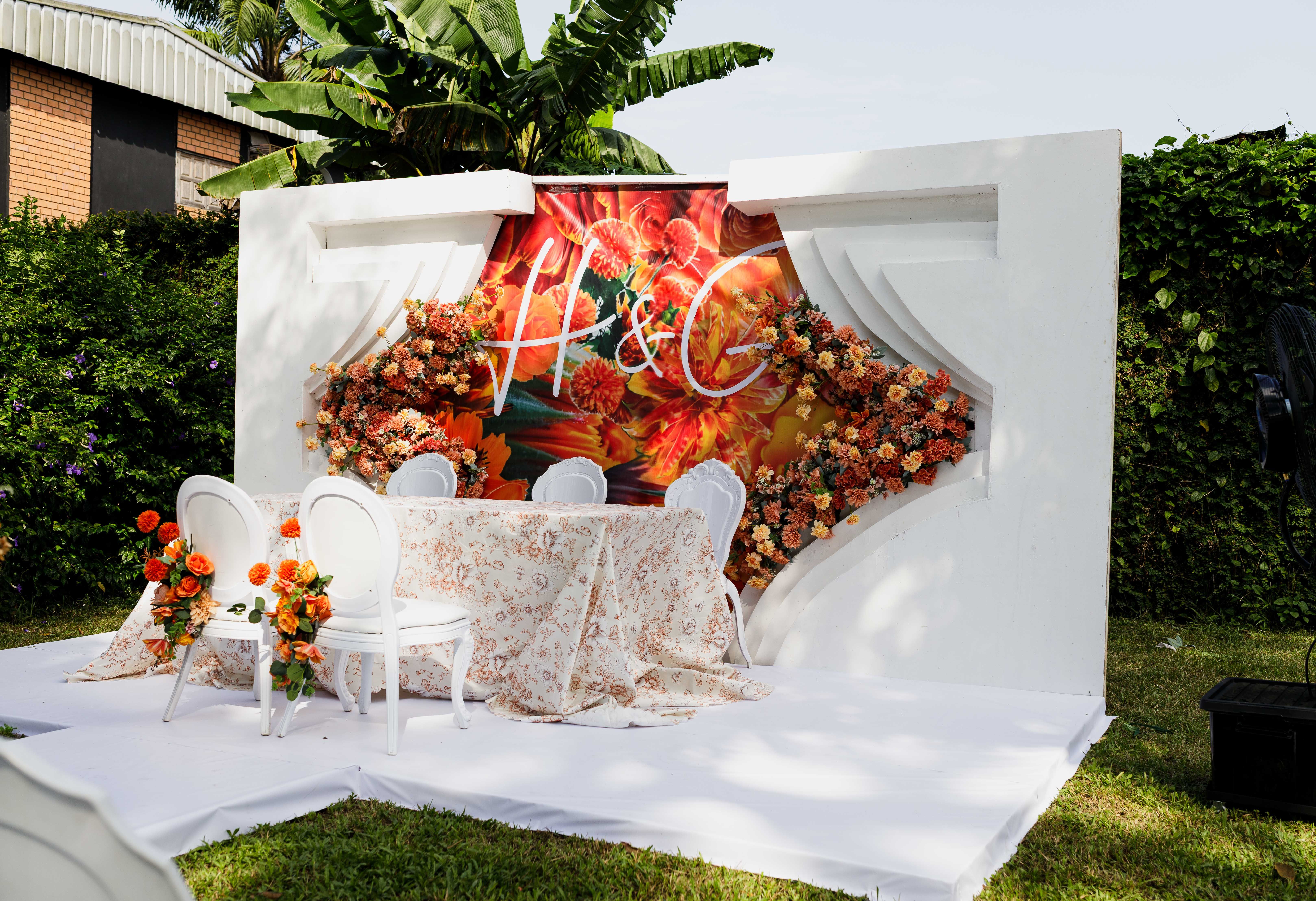Beautifully decorated outdoor wedding reception setup with floral arrangements.