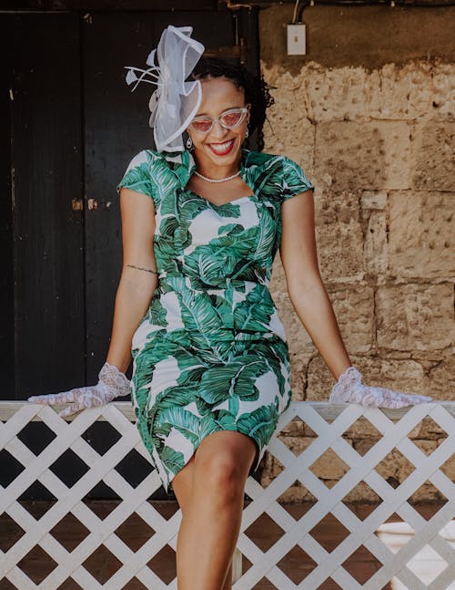 Woman in Green and White Floral Dress Wearing White Floral Headdress