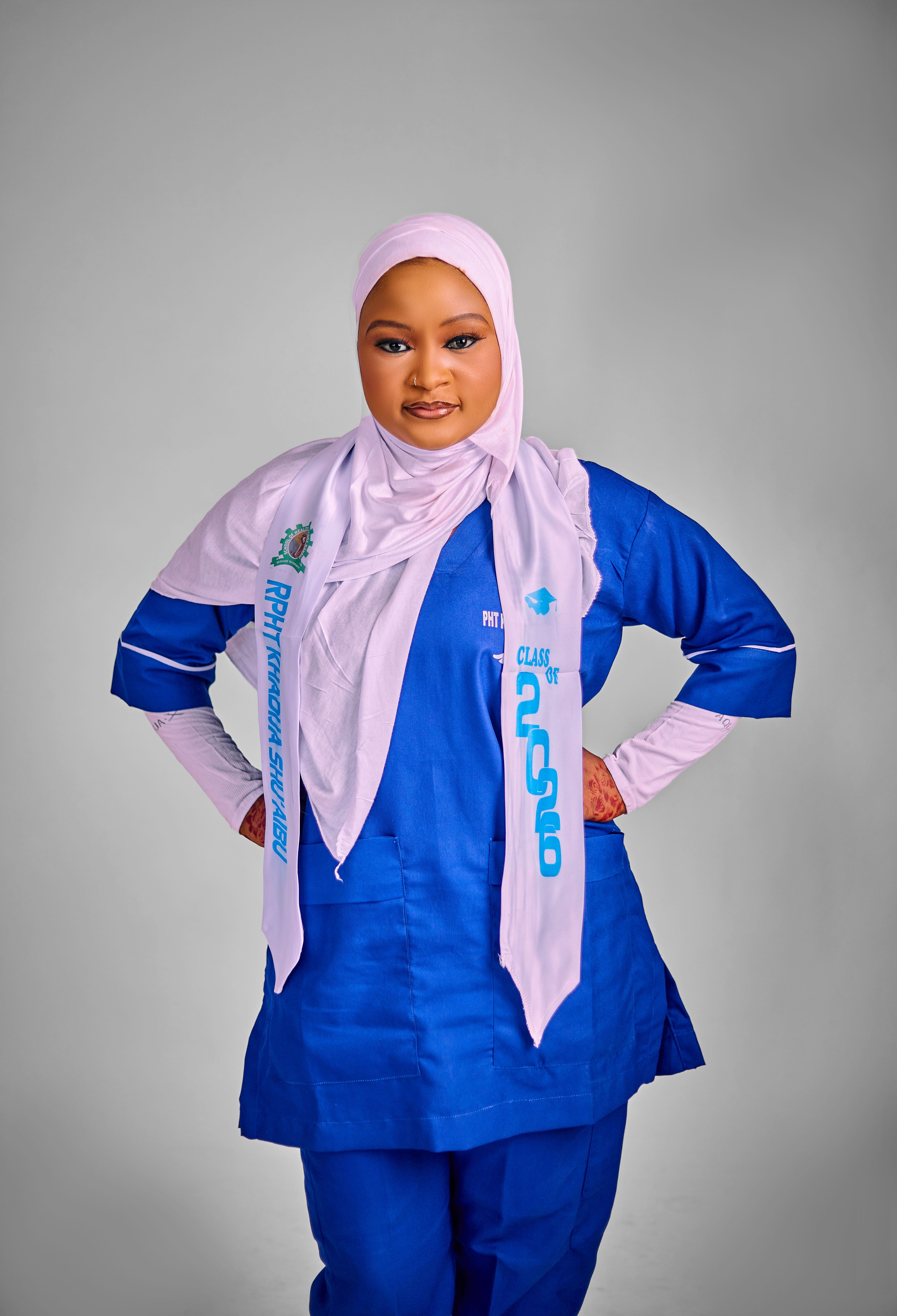 Portrait of a confident nurse in a blue uniform with hijab.