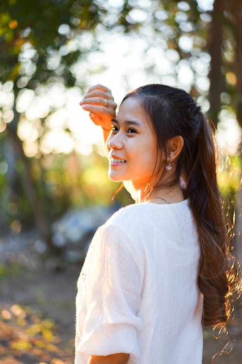 Charming ethnic woman in sunny park