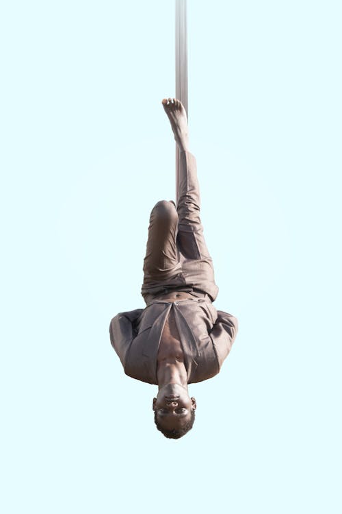 A Man Hanging on Gymnastics Cloth