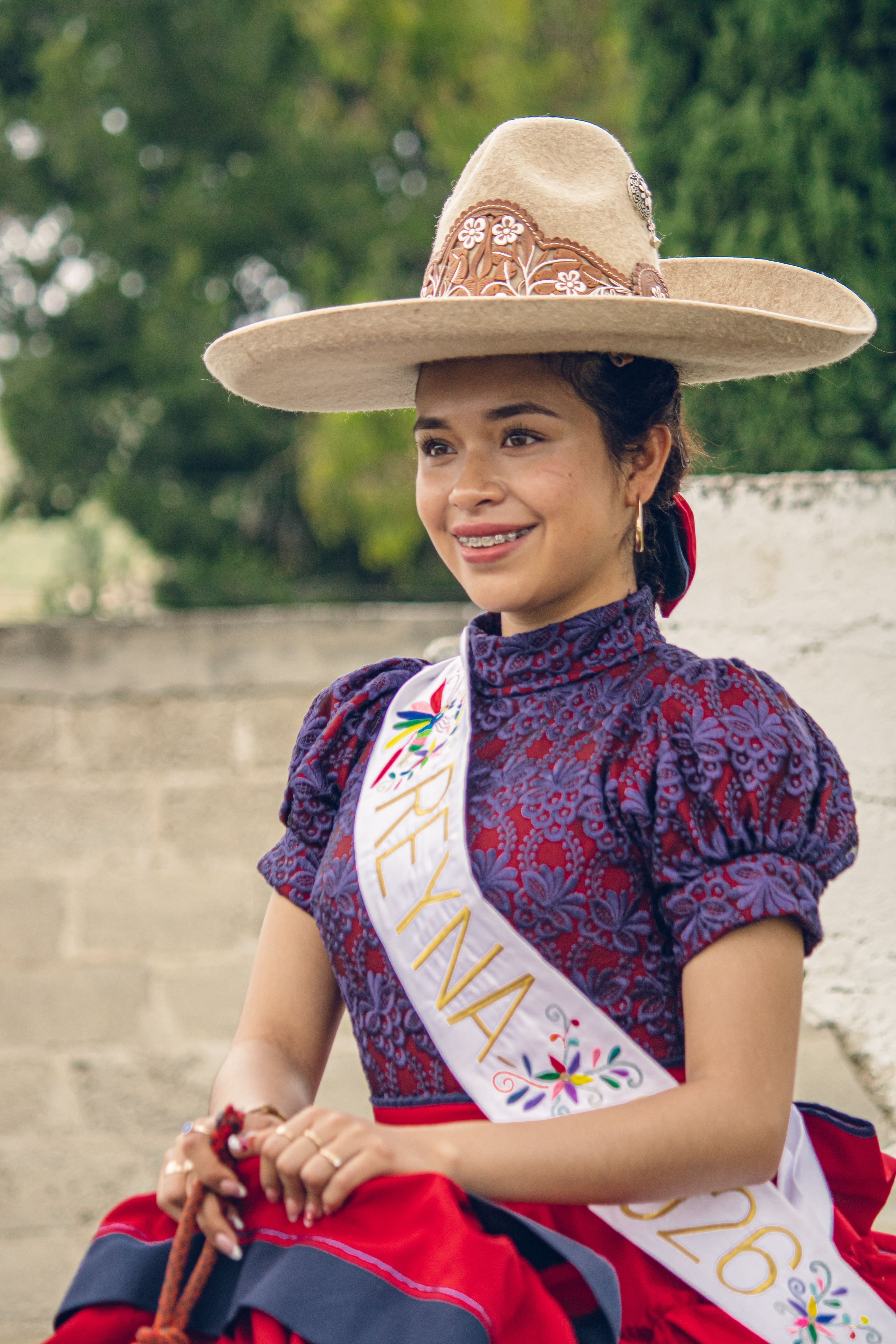 Portrait of a young woman in traditional Mexican attire during a Pachuca festival.