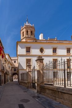 Charming historic street scene with architecture in Lorca, Murcia, under a bright blue sky.