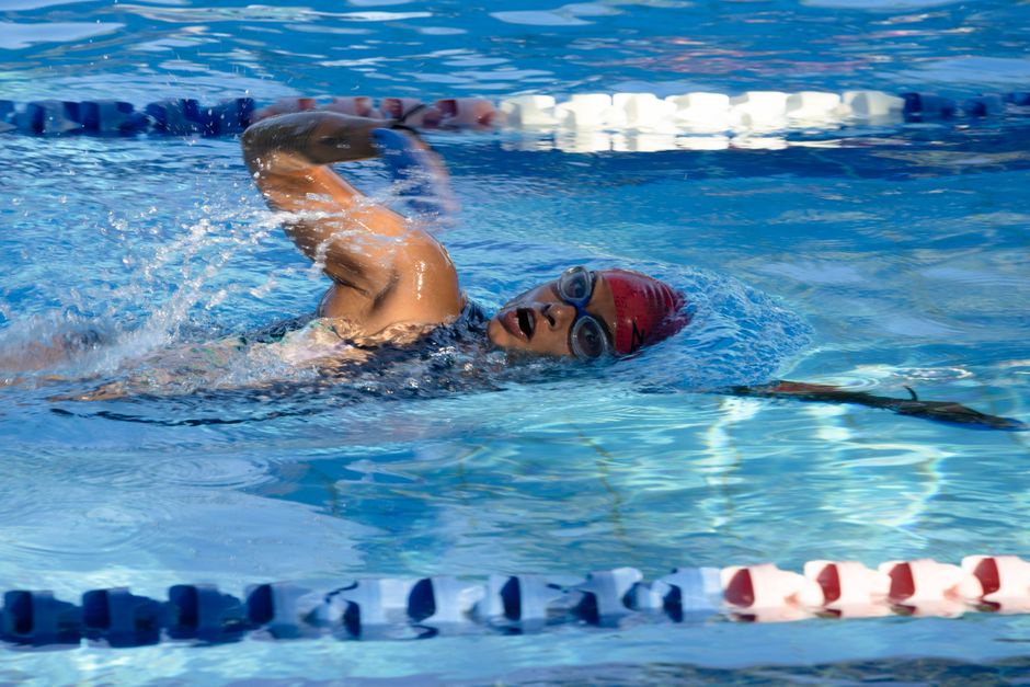 Adult swimmer doing laps in a bright, clean indoor pool facility Adult swimmer doing laps in a bright, clean indoor pool facility