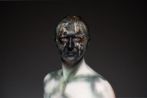 Man with black and gold body art