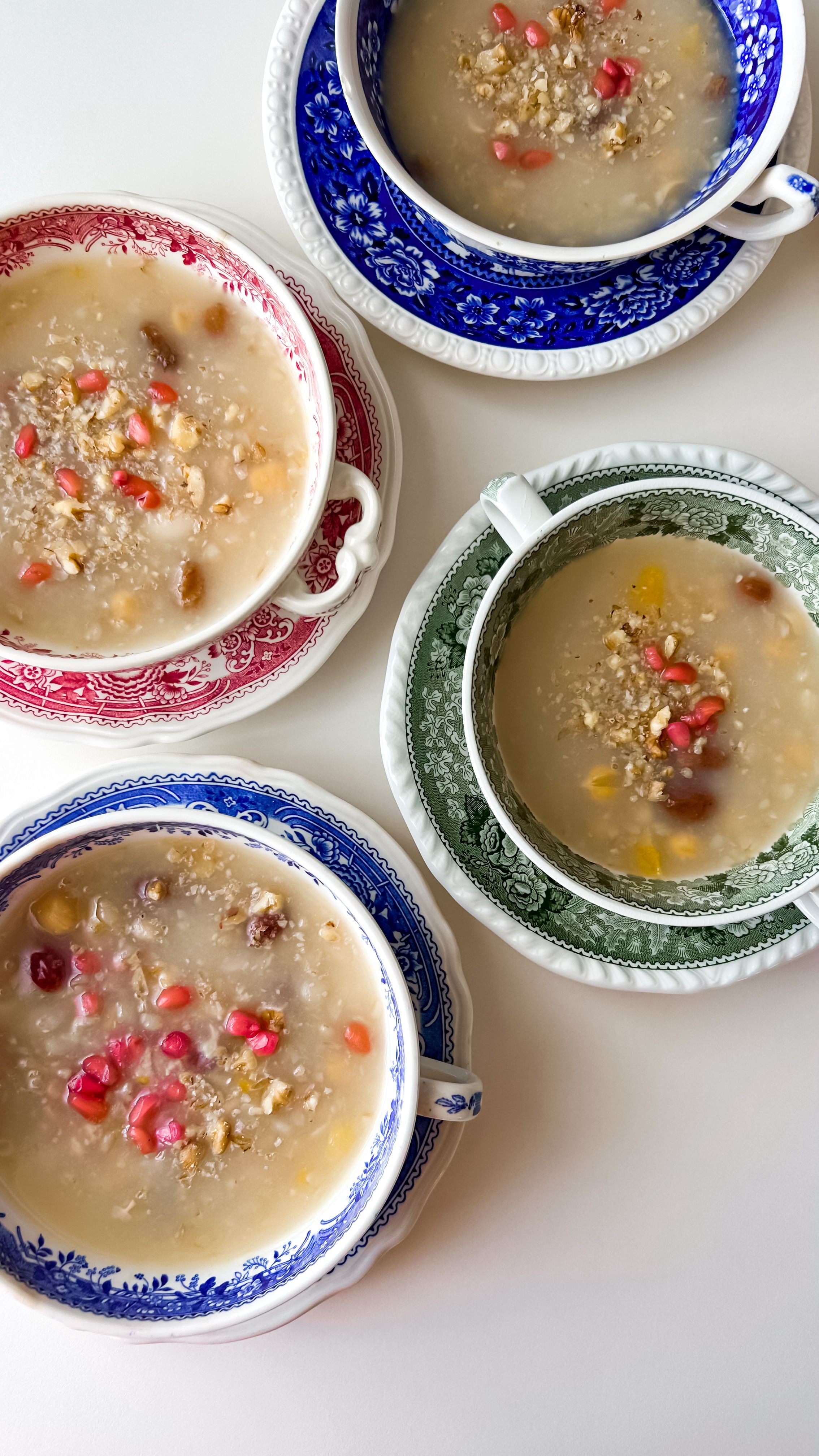 Overhead view of colorful bowls filled with nutritious oatmeal topped with fresh fruit and nuts.