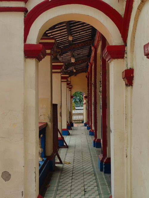 Free A traditional corridor with arches and detailed tile floor in Ho Chi Minh City, Vietnam. Stock Photo