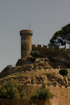 Historic tower with stone walls in Tossa de Mar, a picturesque coastal town in Spain.