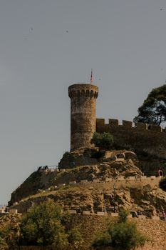 Scenic view of a medieval tower in Tossa de Mar, perfect for historical exploration.