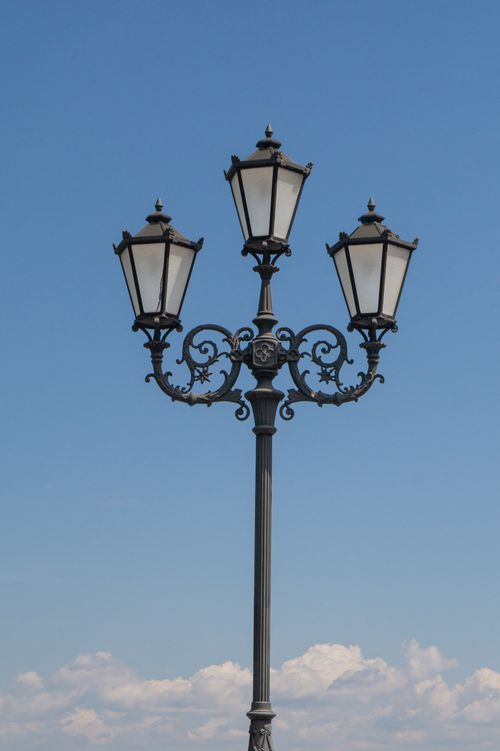 Free Elegant lamp post with artistic ironwork against a blue sky in Kyiv, Ukraine, showcasing historic city charm. Stock Photo