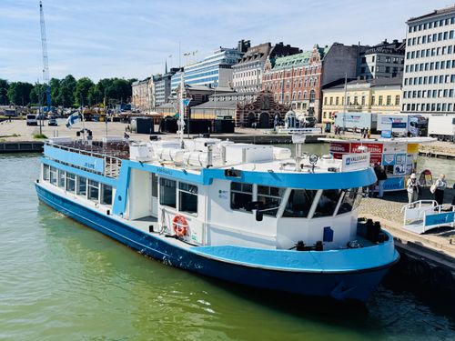 Free A ferry docked in Helsinki harbor with cityscape background on a sunny day. Stock Photo