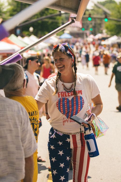 Free A vibrant street festival in Brevard, North Carolina, celebrating Independence Day with lively participants and American pride. Stock Photo