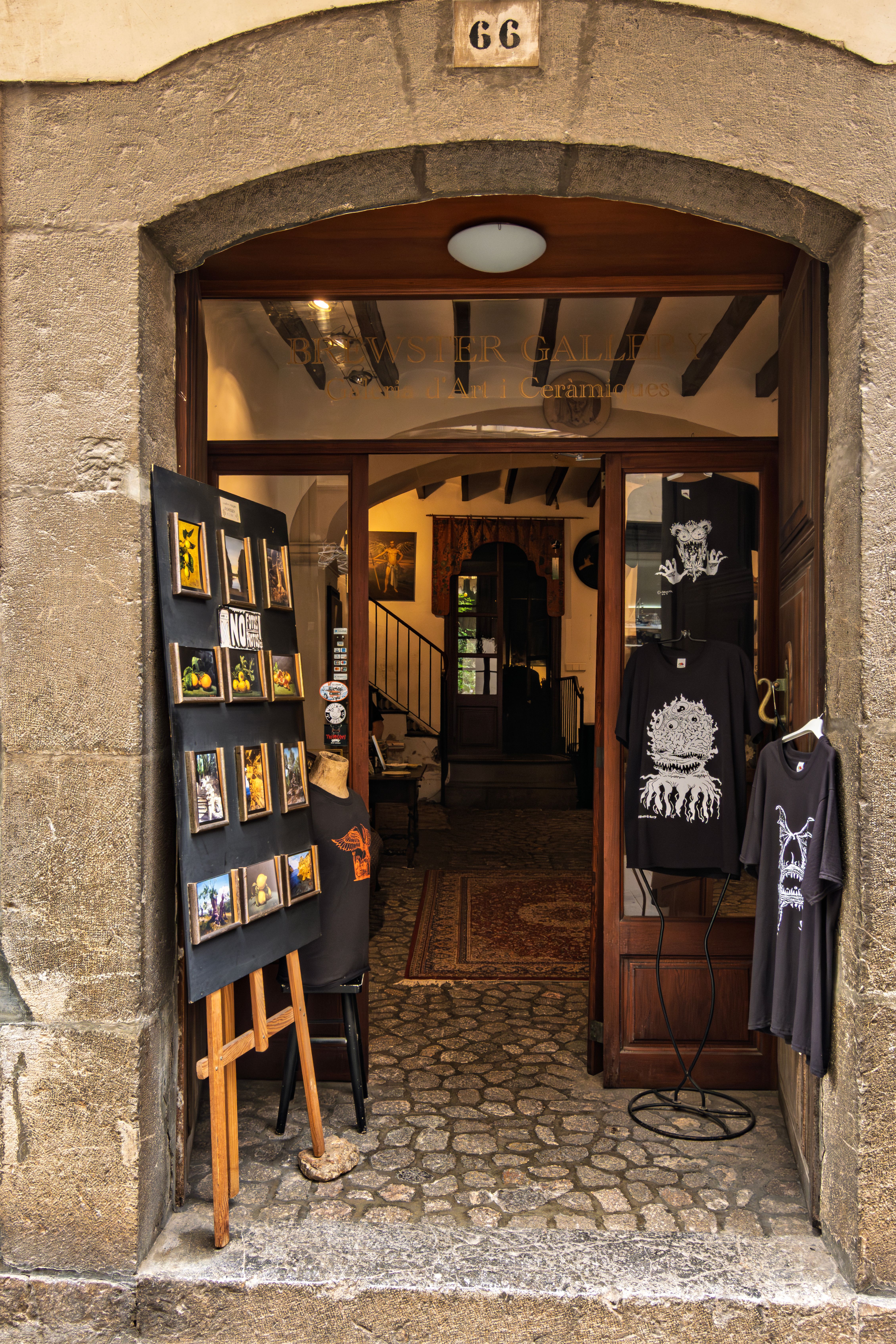 Charming art shop entrance with display easel and vintage decor, inviting ambiance.