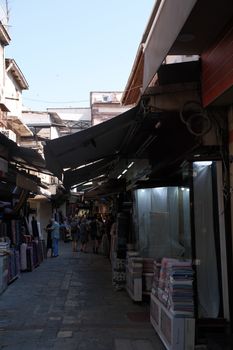 Explore vibrant market streets in İzmir with shops offering various textiles.