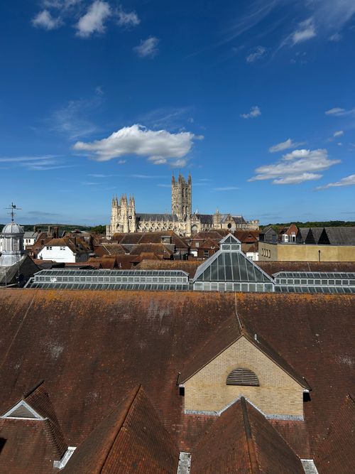 Free A captivating aerial view of the historic Canterbury Cathedral under a clear blue sky. Stock Photo