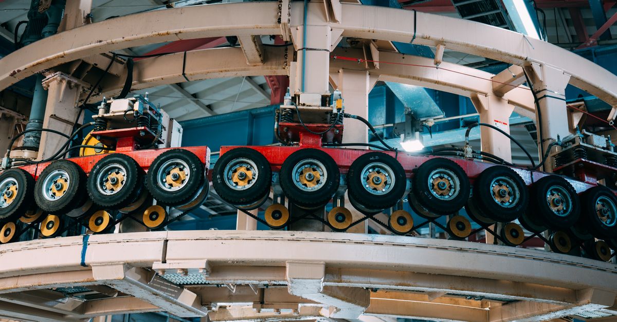 Close-up view of a complex industrial conveyor system inside a manufacturing facility.