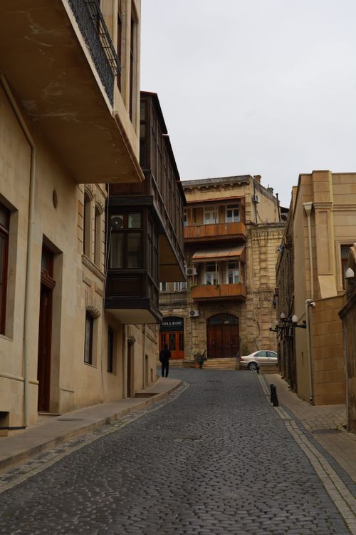 Free A narrow cobblestone street winding through historic architecture, featuring old stone buildings. Stock Photo