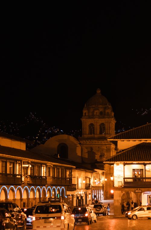 Free Bustling night view of Cusco city center showcasing historic architecture and vibrant street life. Stock Photo