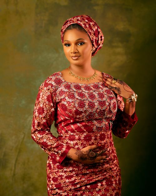 Free Portrait of a woman in vibrant traditional African clothing with henna designs. Stock Photo