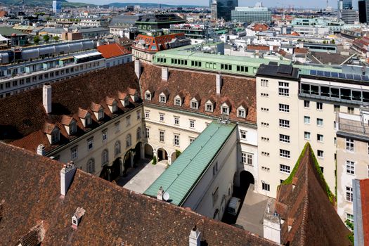 Aerial photo of historic buildings in Vienna's cityscape under a clear sky.