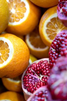Vibrant close-up of sliced oranges and pomegranate seeds showcasing fresh produce.